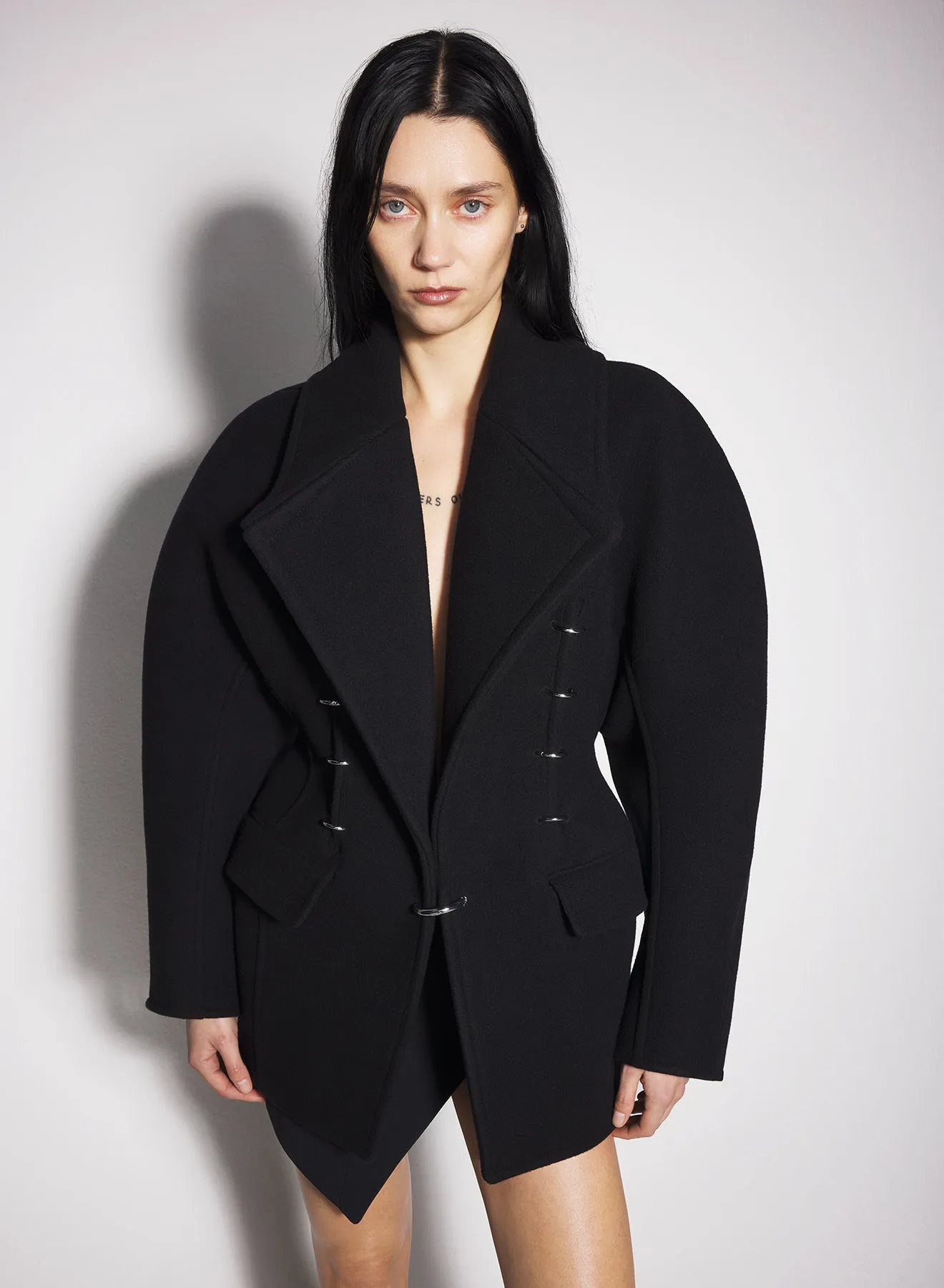 black pierced wool coat